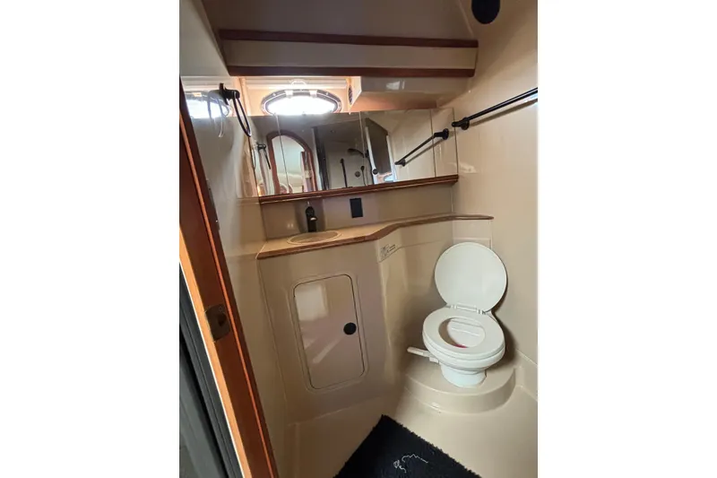Slide: The Image of Bathroom interior of 2000 Cruisers 3870 yacht, featuring toilet and sink. - 48