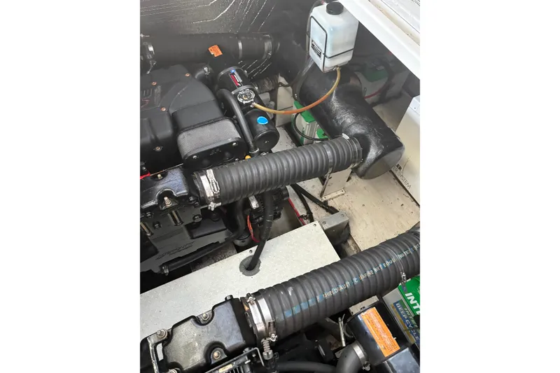 Slide: The Image of Engine compartment of a 2000 Cruisers 3870 boat, showing hoses and components. - 58