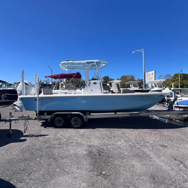 The Image of 2023 Sea Pro 248 Bay boat on trailer outdoors. - 0
