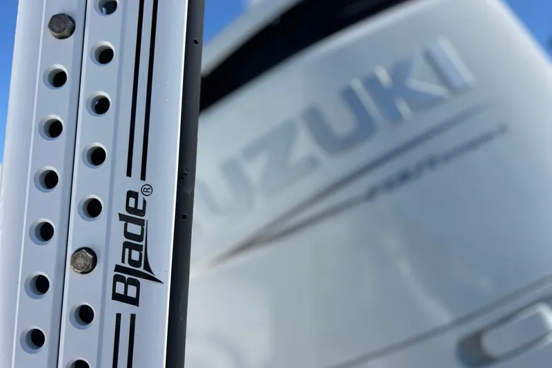 Slide: The Image of Close-up of Blade component on 2023 Sea Pro 248 Bay boat with Suzuki branding. - 12
