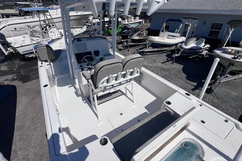 Slide: The Image of 2023 Sea Pro 248 Bay boat with dual seats and center console in a marina. - 13