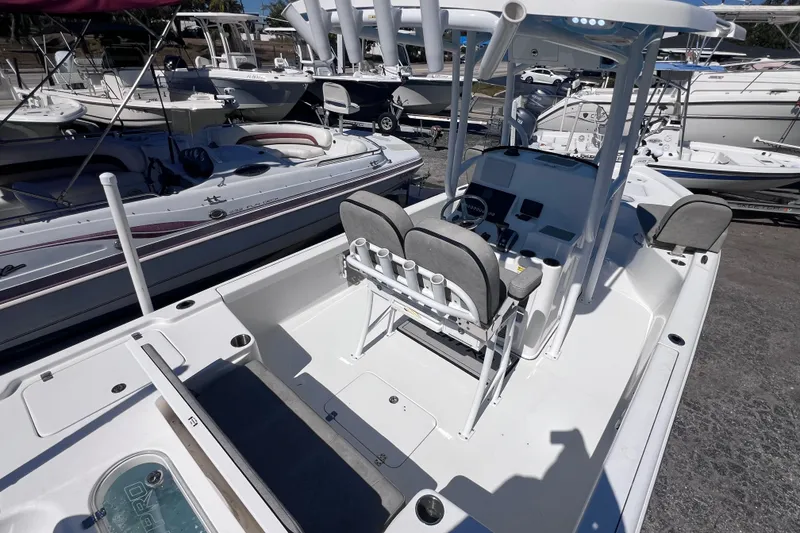 Slide: The Image of 2023 Sea Pro 248 Bay boat with center console and seating, docked among other boats. - 14