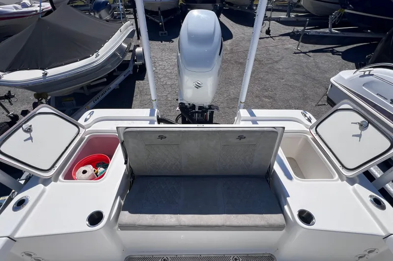 Slide: The Image of 2023 Sea Pro 248 Bay boat with storage compartments and outboard motor. - 17
