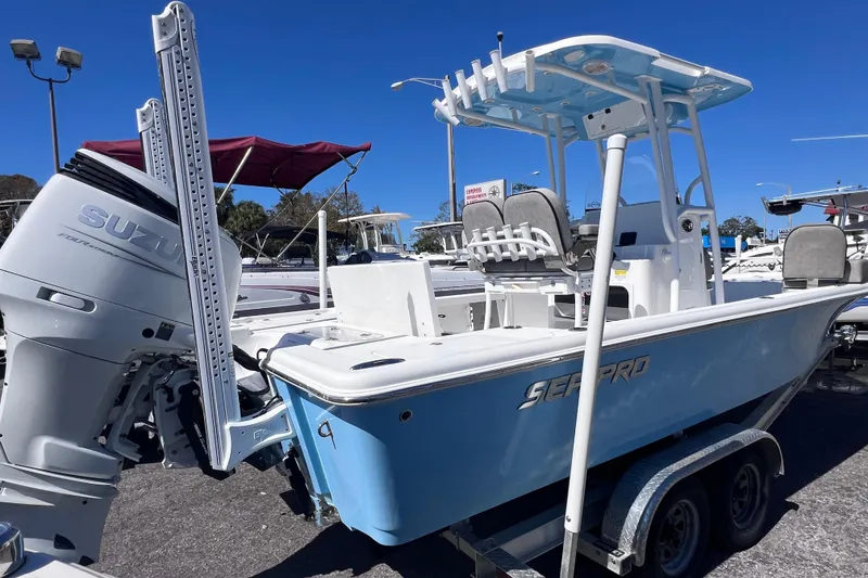 Slide: The Image of 2023 Sea Pro 248 Bay boat with Suzuki outboard motor on trailer. - 2