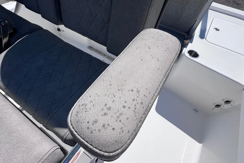 Slide: The Image of 2023 Sea Pro 248 Bay boat seat with textured armrest and cup holder. - 22