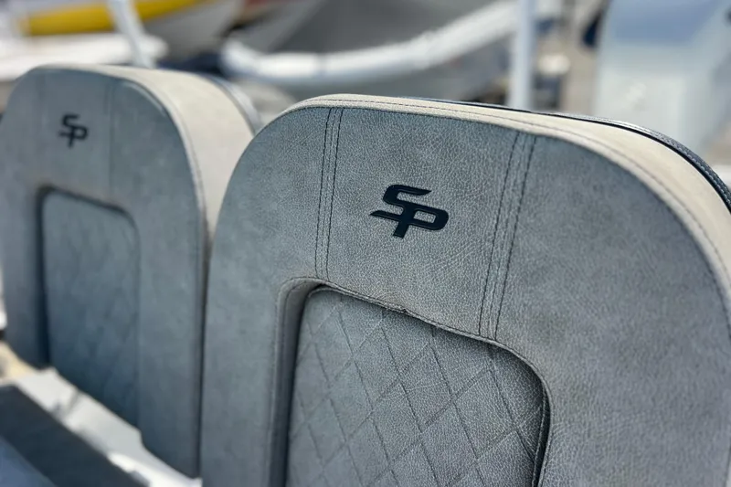 Slide: The Image of 2023 Sea Pro 248 Bay boat seats with embroidered logo, featuring gray upholstery. - 23