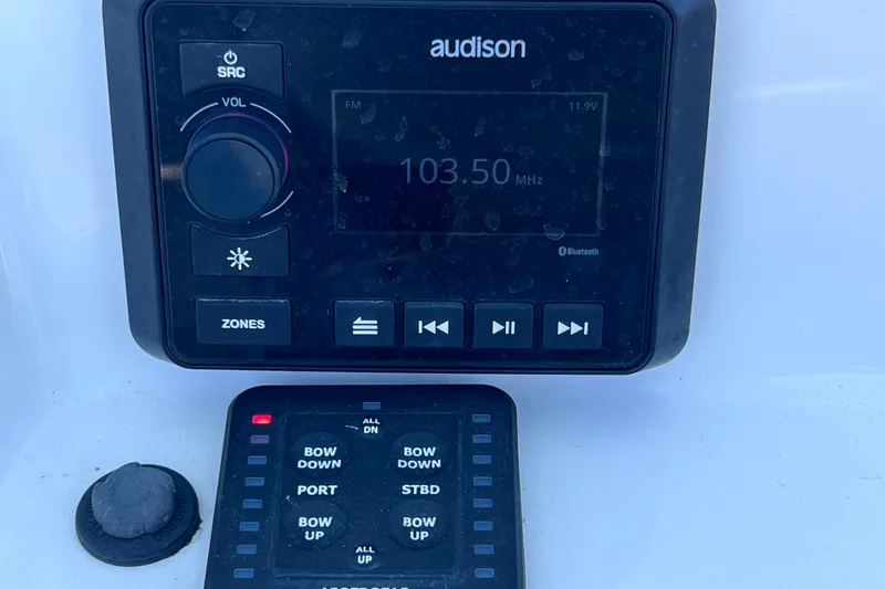 Slide: The Image of 2023 Sea Pro 248 Bay audio control panel with Audison system and button interface. - 29