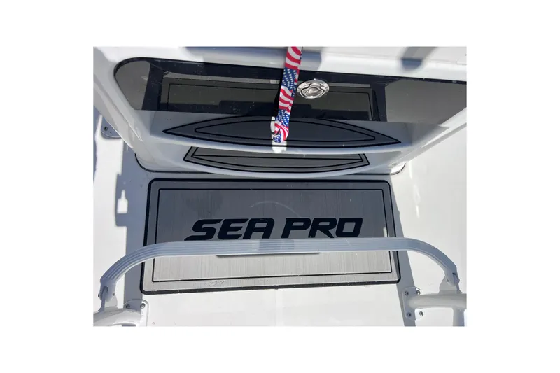 Slide: The Image of 2023 Sea Pro 248 Bay boat deck with logo and American flag detail. - 31