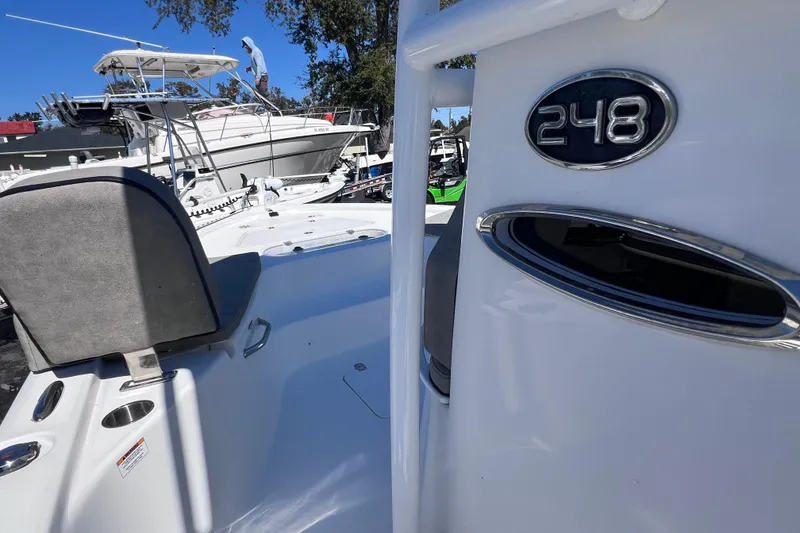 Slide: The Image of 2023 Sea Pro 248 Bay boat interior with seating and model emblem. - 32