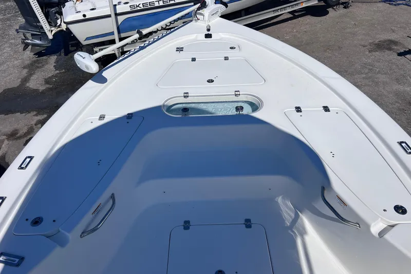 Slide: The Image of 2023 Sea Pro 248 Bay boat deck with storage compartments and seating area. - 39