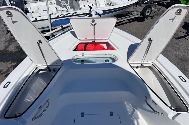 Slide: The Image of 2023 Sea Pro 248 Bay boat with open storage compartments and visible interior features. - 40