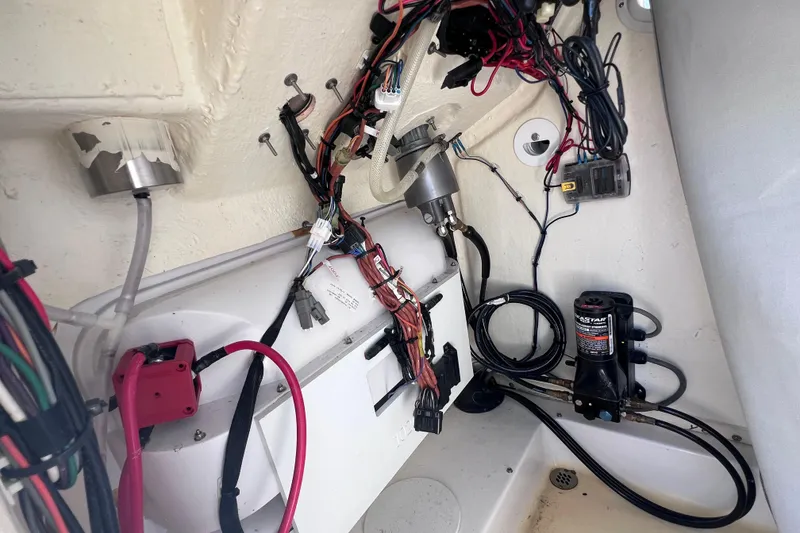 Slide: The Image of 2023 Sea Pro 248 Bay boat wiring and components in the interior compartment. - 45