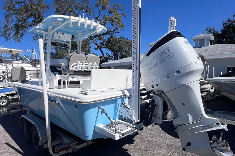 Slide: The Image of 2023 Sea Pro 248 Bay boat with Suzuki outboard motor, parked on a trailer. - 5