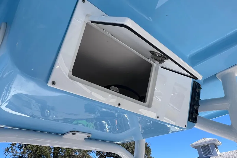 Slide: The Image of 2023 Sea Pro 248 Bay boat storage compartment, open, with blue exterior. - 51