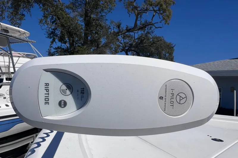 Slide: The Image of 2023 Sea Pro 248 Bay boat with Riptide i-Pilot GPS system, clear blue sky background. - 52