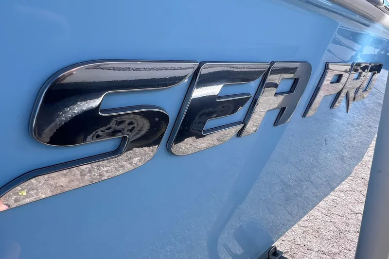 Slide: The Image of 2023 Sea Pro 248 Bay boat logo on a sleek blue hull. - 6