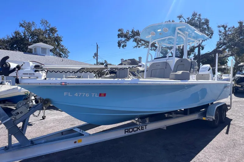 Slide: The Image of 2023 Sea Pro 248 Bay boat on trailer, light blue, parked outdoors. - 7