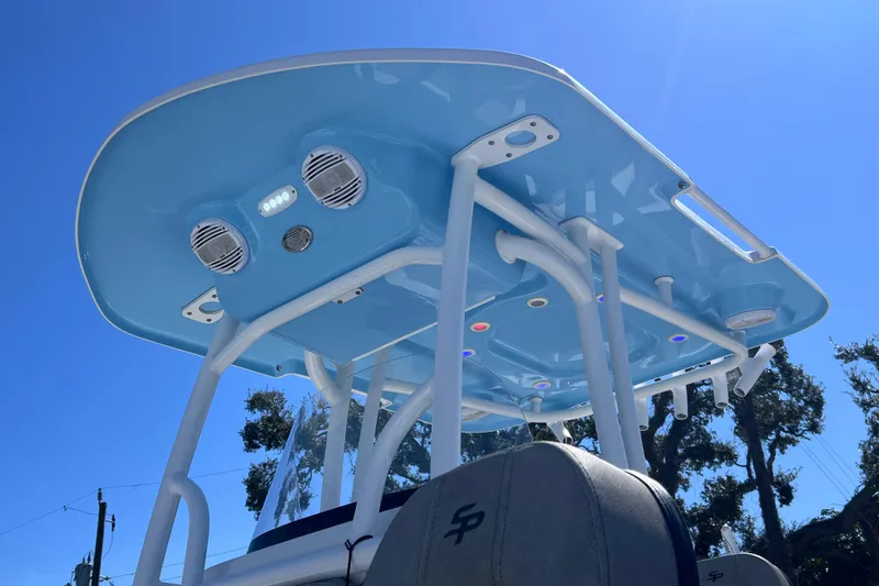 Slide: The Image of 2023 Sea Pro 248 Bay boat with blue T-top and integrated speakers. - 8