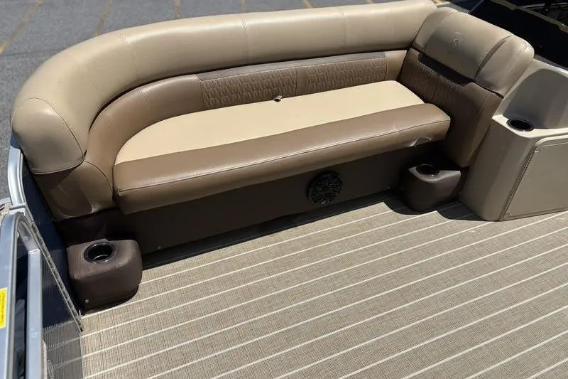 Slide: The Image of 2021 Godfrey Sweetwater 2086 C boat interior with beige seating and cup holders. - 10