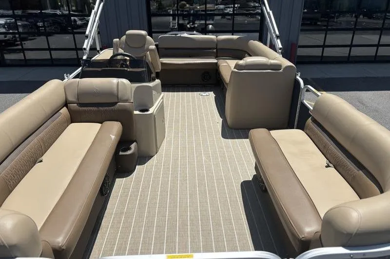 Slide: The Image of 2021 Godfrey Sweetwater 2086 C pontoon boat interior with beige seating and spacious layout. - 12