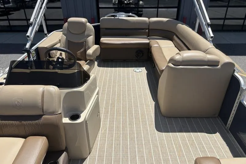 Slide: The Image of 2021 Godfrey Sweetwater 2086 C pontoon boat interior with beige seating and steering console. - 14