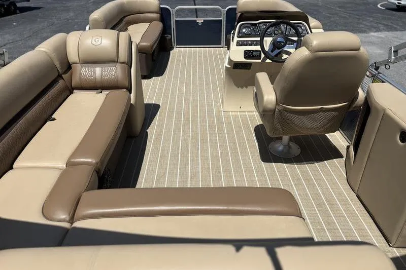 Slide: The Image of 2021 Godfrey Sweetwater 2086 C pontoon boat interior with beige seating and steering console. - 17