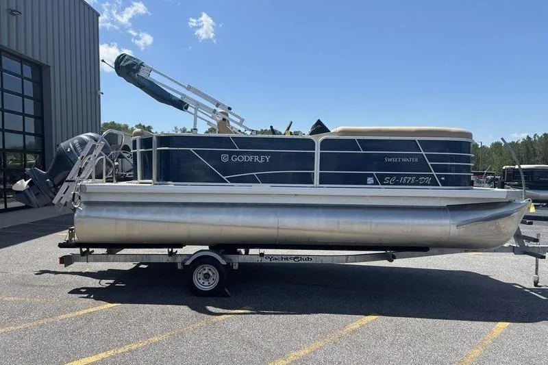 Slide: The Image of 2021 Godfrey Sweetwater 2086 C pontoon boat on trailer, parked outdoors. - 5