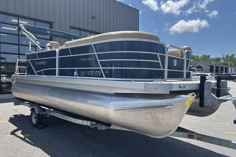 Slide: The Image of 2021 Godfrey Sweetwater 2086 C pontoon boat on trailer, parked outdoors. - 6
