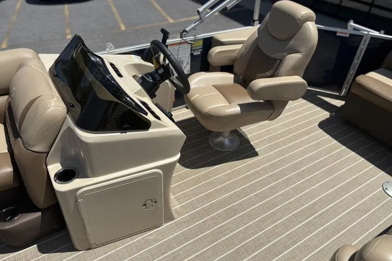 Slide: The Image of 2021 Godfrey Sweetwater 2086 C boat interior with beige captain's chair and steering console. - 8
