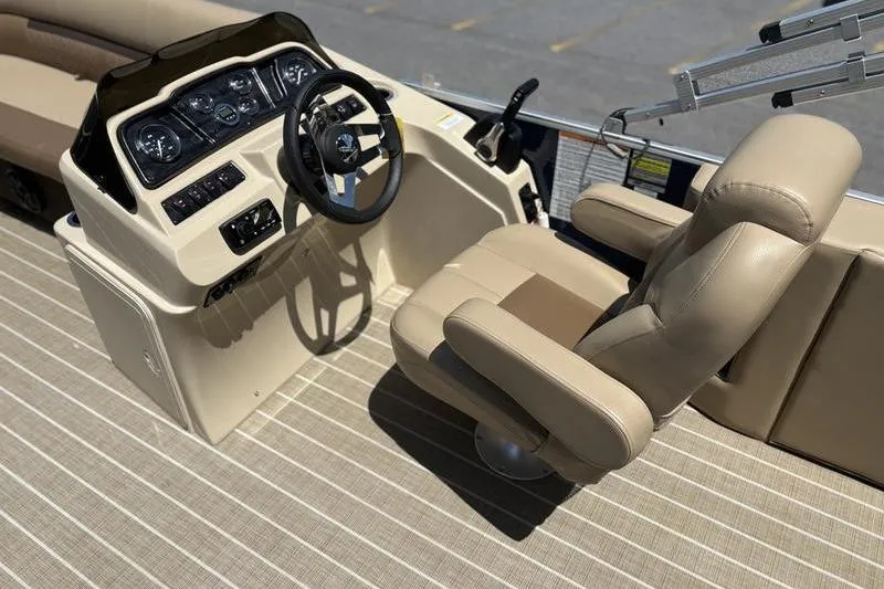 Slide: The Image of 2021 Godfrey Sweetwater 2086 C boat interior with steering console and beige captain's chair. - 9