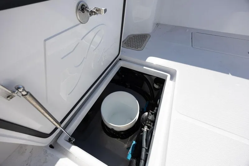 Slide: The Image of 2025 Front Runner 36 Center Console boat storage compartment with open hatch and visible equipment. - 14