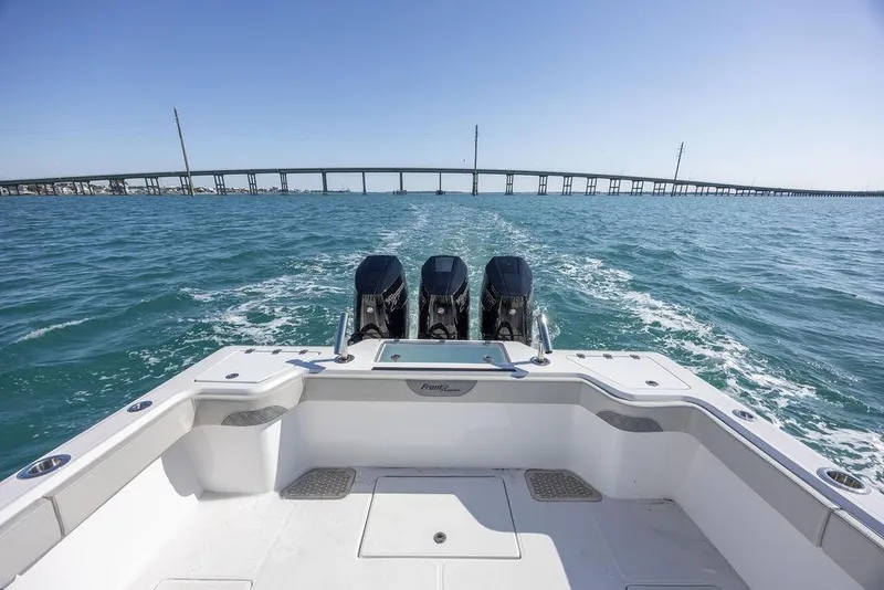 Slide: The Image of 2025 Front Runner 36 Center Console boat on open water with bridge in background. - 15