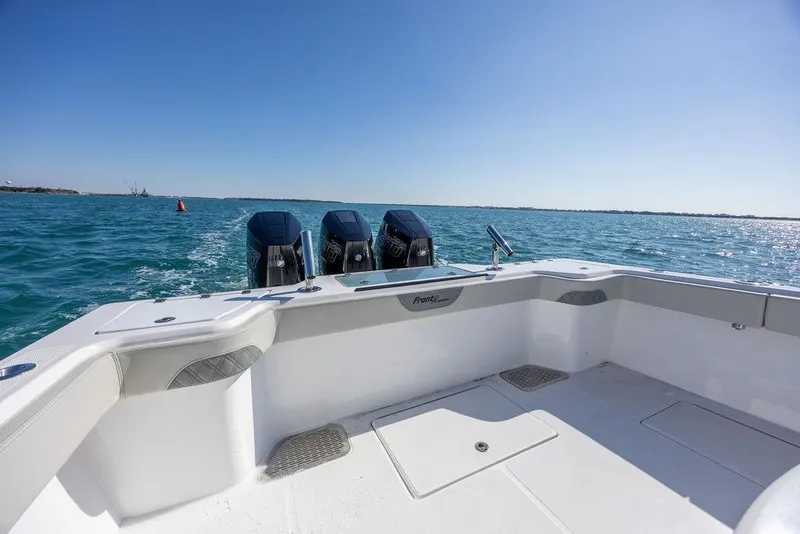 Slide: The Image of 2025 Front Runner 36 Center Console boat on open water, featuring triple outboard engines. - 16