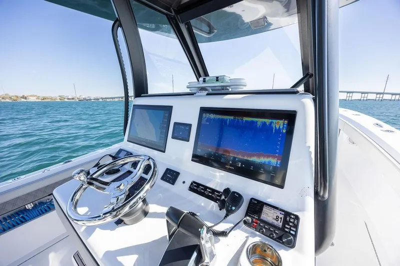 Slide: The Image of 2025 Front Runner 36 Center Console boat dashboard with advanced navigation displays. - 5