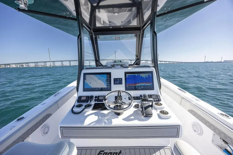 Slide: The Image of 2025 Front Runner 36 Center Console boat dashboard with navigation screens on open water. - 6