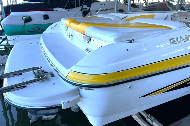 Slide: The Image of 2007 Glastron GT 205 boat with yellow accents docked in marina. - 14