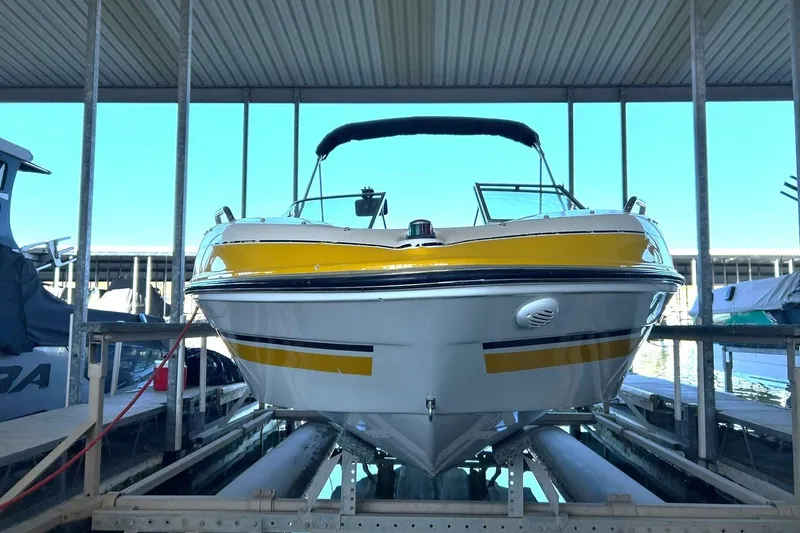 Slide: The Image of 2007 Glastron GT 205 boat docked, featuring a yellow and white exterior. - 15