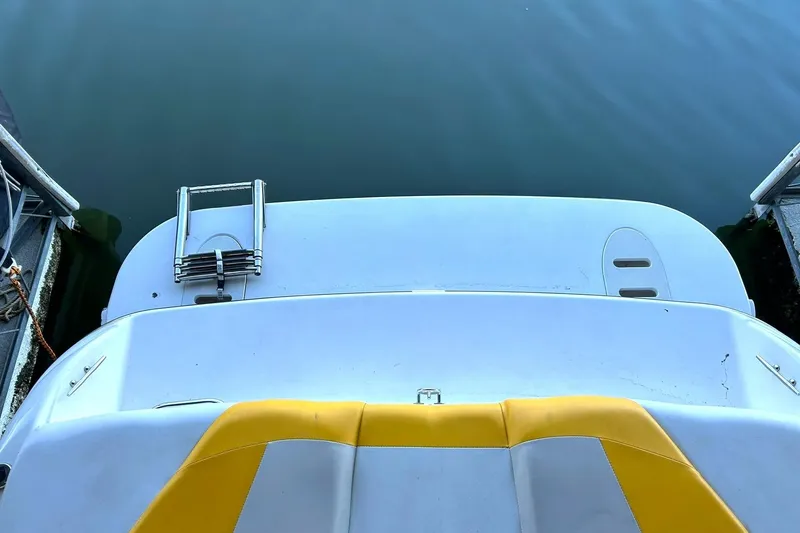 Slide: The Image of 2007 Glastron GT 205 boat with yellow seating and swim platform ladder. - 17