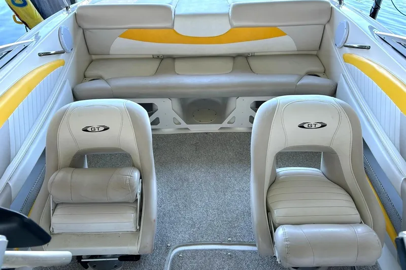 Slide: The Image of 2007 Glastron GT 205 boat interior with beige and yellow seating. - 21