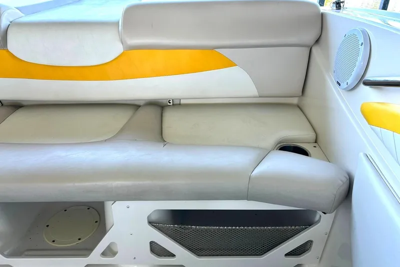 Slide: The Image of 2007 Glastron GT 205 boat interior with gray and yellow seating, speaker, and cup holder. - 23