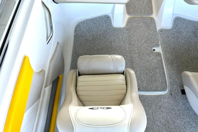 Slide: The Image of 2007 Glastron GT 205 boat interior with beige seating and gray carpet flooring. - 24
