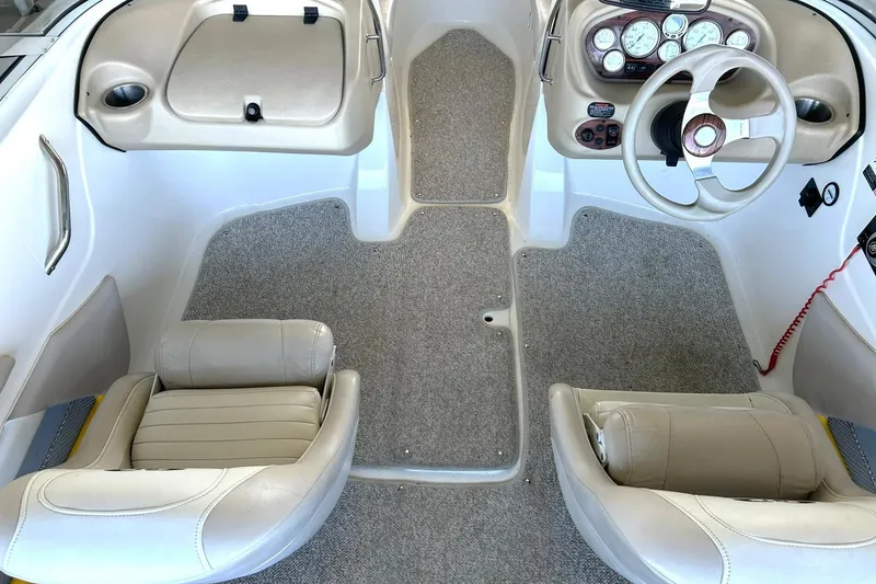 Slide: The Image of 2007 Glastron GT 205 boat interior with beige seats and dashboard controls. - 26