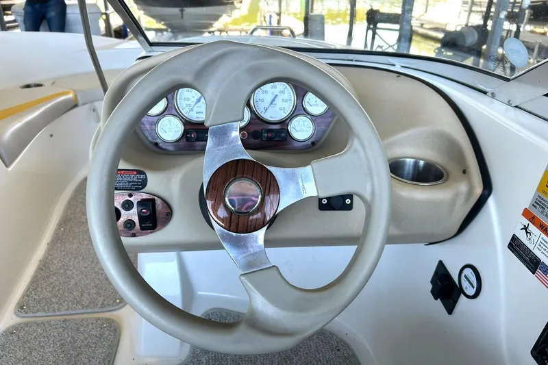 Slide: The Image of Steering wheel and dashboard of a 2007 Glastron GT 205 boat. - 28
