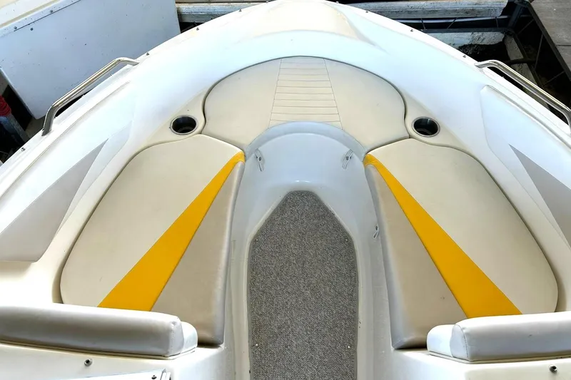 Slide: The Image of 2007 Glastron GT 205 boat interior with yellow-accented seating and carpeted flooring. - 29