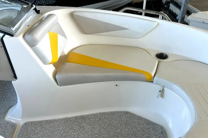 Slide: The Image of 2007 Glastron GT 205 boat interior with yellow and gray seating, cup holder, and carpeted floor. - 31