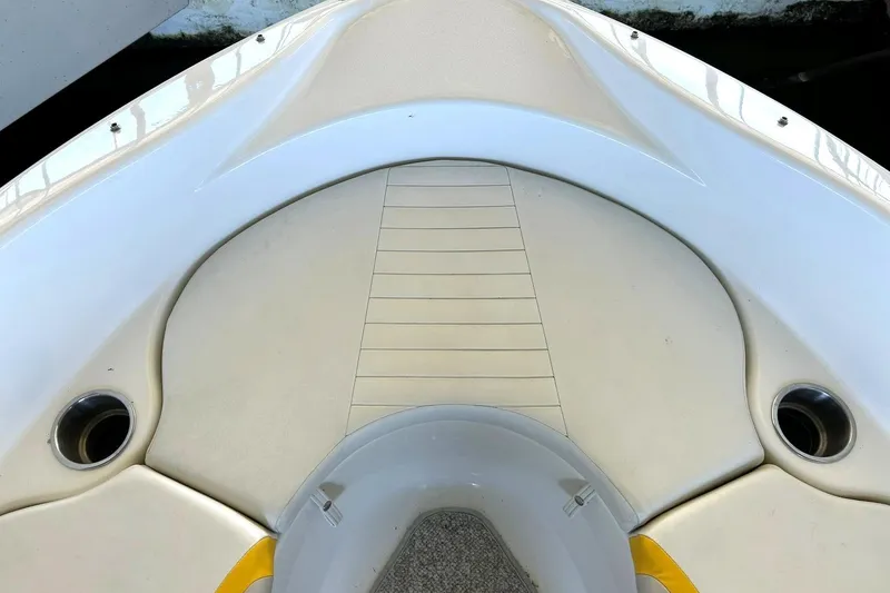 Slide: The Image of 2007 Glastron GT 205 boat interior, featuring white seating and cup holders. - 32