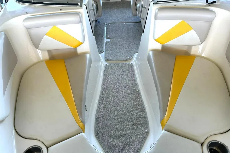 Slide: The Image of 2007 Glastron GT 205 boat interior with yellow and gray seating, carpeted floor. - 33