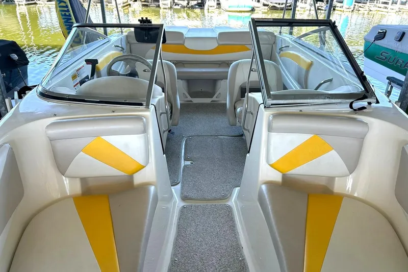 Slide: The Image of 2007 Glastron GT 205 boat interior with yellow accents and seating. - 34