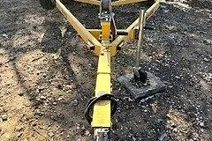 Slide: The Image of Yellow trailer hitch for 2007 Glastron GT 205 boat on gravel surface. - 38