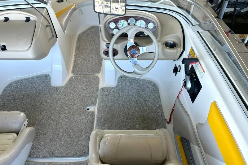 Slide: The Image of 2007 Glastron GT 205 boat interior with steering wheel and dashboard controls. - 4